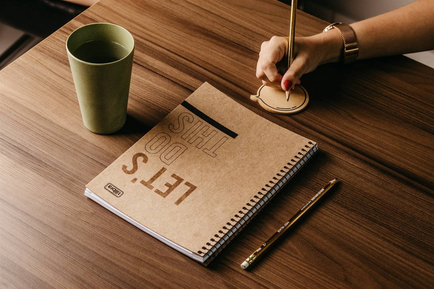 Un carnet ouvert avec la mention Let's do this, à côté d'un café